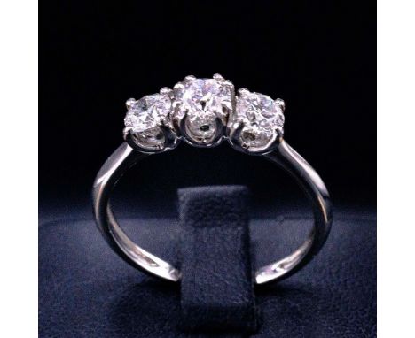 A PLATINUM DIAMOND TRILOGY RING. set with three round brilliant cut diamonds, each of approximately 0.25 carats, individually