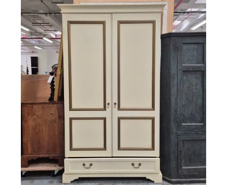 WARDROBE. cream and gilt, with a hanging rail and a drawer beneath 62cm d x 220cm t x 126cm w.