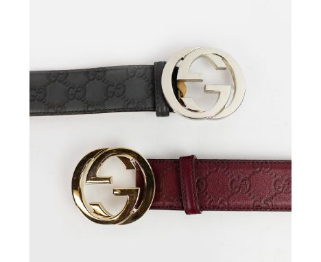 2 GUCCI BELTS. both with embossed GG logo, grey leather with silver tone hardware, size 85/34, made in Italy together with an