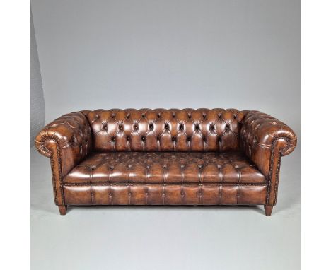 CHESTERFIELD SOFA. Buttoned tan leather, labeled Distinctive Chesterfields, 80cm H x 210cm W x 90cm D.