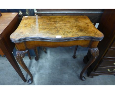 A George I style walnut serpentine fold over card table 