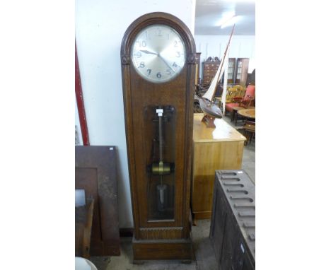 An early 20th Century oak electric longcase clock 