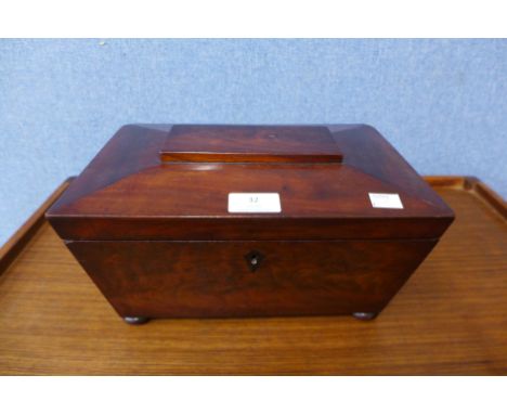 A Victorian flame mahogany sarcophogus shaped tea caddy 