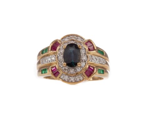 GEM SET AND DIAMOND RING, set with a central oval sapphire with diamonds, rubies and emeralds to the bezel, the diamonds tota