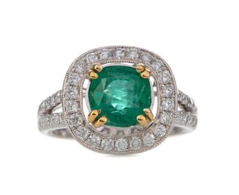 EMERALD AND DIAMOND RING, the central cushion cut emerald of approximately 1.88 carats, within a round brilliant cut diamond 