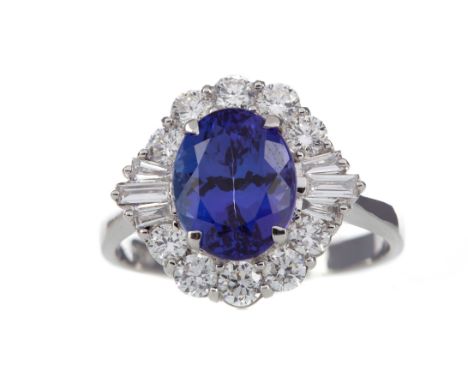CERTIFICATED TANZANITE AND DIAMOND RING, set with an oval tanzanite of approximately 3.00 carats, flanked by tapered baguette