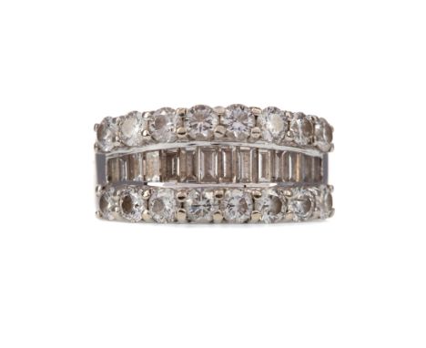 DIAMOND DRESS RING, set with a central row of baguette cut diamonds within a round brilliant cut diamond border, the diamonds