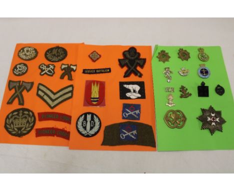 A selection of various military badges including Army Chaplains Department, Sea Cadet Corps, NAAFI,  cloth Bomb Disposal and 