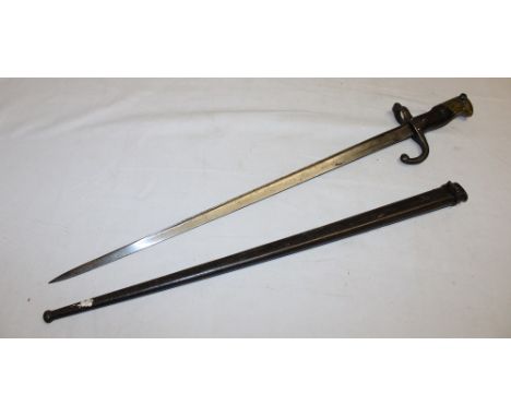 A French Gras bayonet with triangular steel blade marked "D'armes de St. Etienne 1877" in steel scabbard