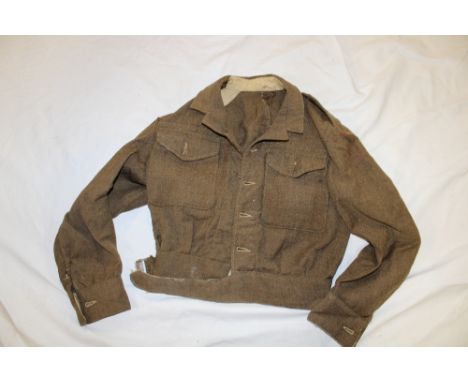 A 1944 pattern khaki battle-dress blouse, minus insignia