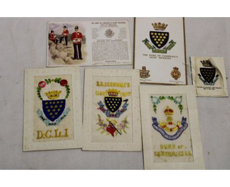 Three First War embroidered silk DCLI Regimental postcards, two other similar postcards and a cigarette card