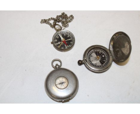 A First War pocket compass dated 1915, nickel mounted pocket compass with interior opening to reveal a collapsible drinking c