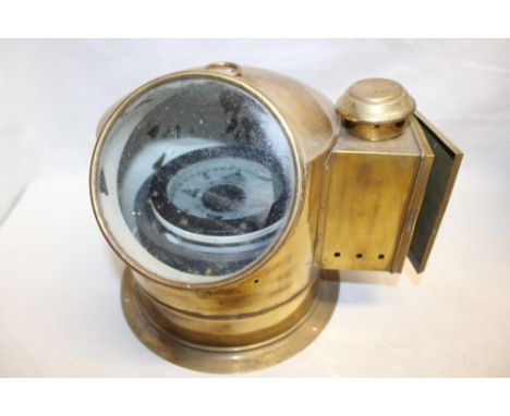 A ship's binnacle compass by Cassens &amp; Plath in brass arched binnacle housing with oil fitment 9½" high