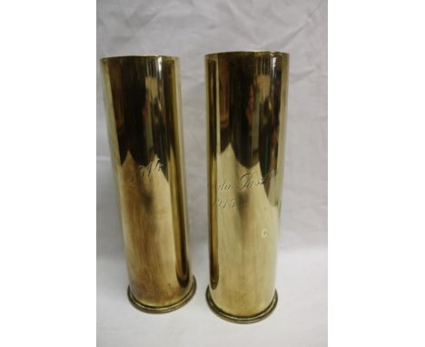 A pair of First War brass shell cases engraved "Yser 1914/Maison du Passeur 1915" 11" high