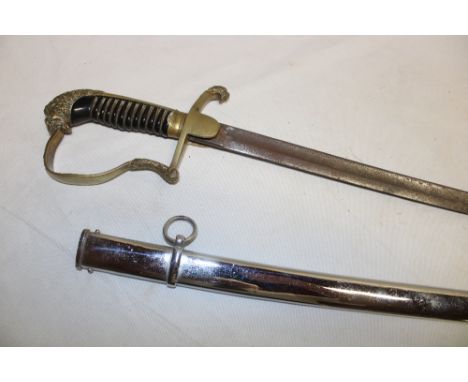 An Imperial German Officer's sword with 33" single-edged steel blade, brass stirrup guard with lion's head pommel in steel sc