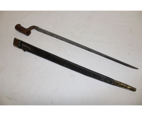 An 1856 pattern Enfield steel socket bayonet with triangular tapered blade in brass mounted leather scabbard