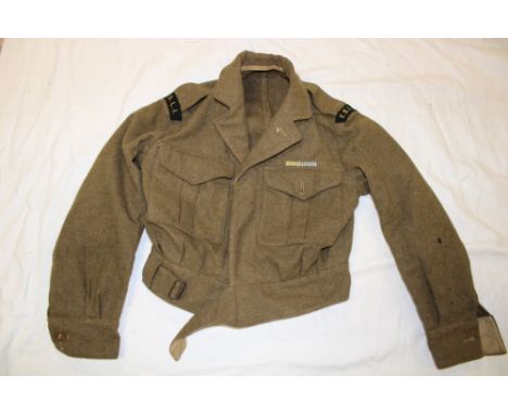 A 1952 khaki battle dress blouse with medal ribbons for Korea named to "S908 Walker"