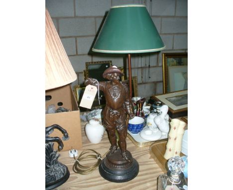 A Spelter " Cavalier" figural table lamp raised on a circular ebonised plinth