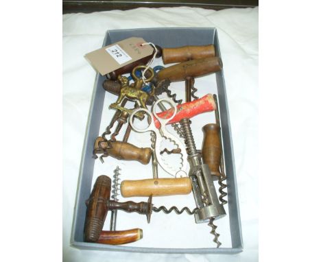 A Collection of vintage corkscrews to a tray including a brass foxhound figural example and turned hardwood examples.