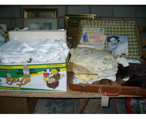 A Collection of vintage linen including christening capes, Victorian underwear, table linen and a vintage suitcase.