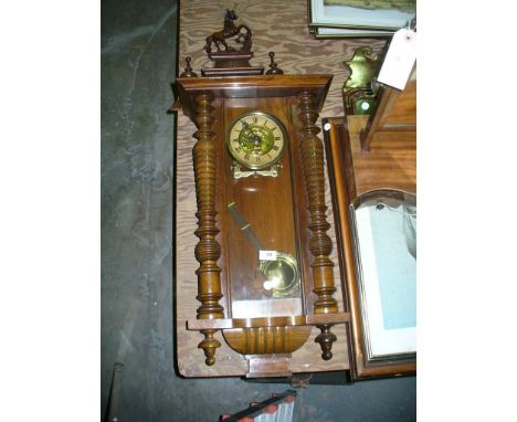 A Victorian walnut cased Vienna style wall clock with a rearing horse crest above an architectural pediment and a gilt metal 