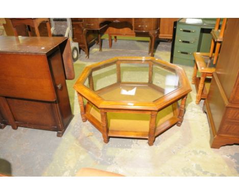 A Modern hardwood glass top octagonal coffee table with a rattan under shelf.