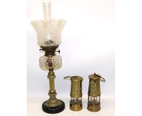 Two reproduction miners lamps incl. one marked Eccles Type 6; and a late C19th/early C20th oil lamp, fluted brass column on b