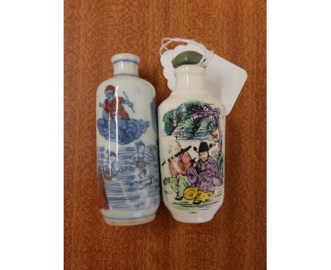 A Chinese porcelain cylindrical snuff bottle decorated in underglaze blue with red to show children playing in water and one 