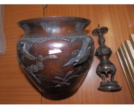 An Oriental bronzed jardiniere (holed) and a pricket candlestick. (2)