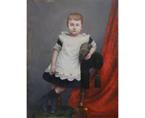 Late 19th/early 20thC School – oil on canvas – Full length portrait of a young boy standing on an upholstered chair beside a 