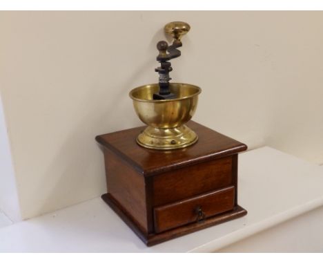 A mahogany based coffee grinder.