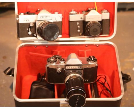 3 vintage film cameras, including Zenit, Petri & Praktica with 35mm, 50mm & 135mm lenses and accessories in lockable hard cas