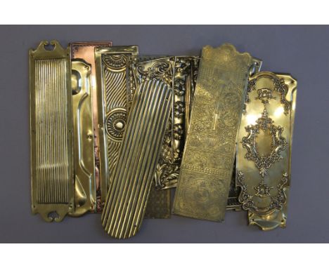 A quantity of antique door finger plates.