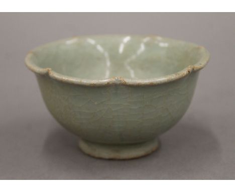 A Chinese light green fluted bowl, Ming Dynasty. 9 cm diameter.Provenance: The Larkin/Minney Collection. 
