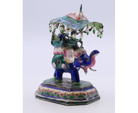 An Eastern unmarked white metal enamel decorated elephant and howdah. 8 cm high.