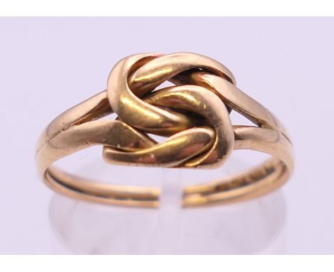 An 18 ct gold lovers knot ring, hallmarked for Chester.  Ring size P/Q. 3.3 grammes total weight.