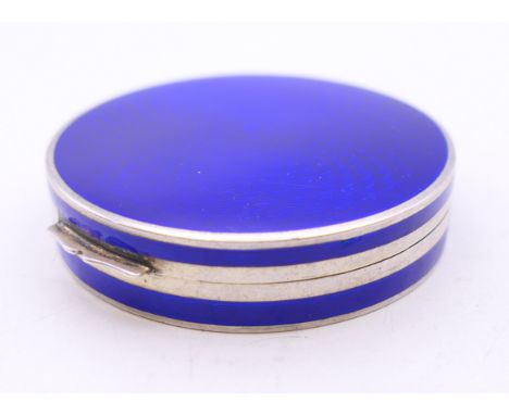 An enamel decorated silver compact.  5 cm diameter. 