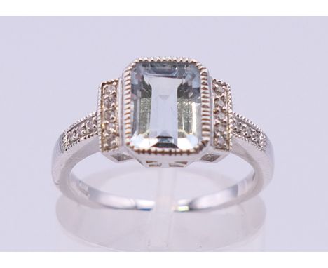 An 18 ct white gold rectangular aquamarine and diamond ring. Ring size L/M. 3.9 grammes total weight.