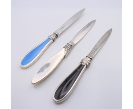 Three silver letter openers, two with enamel decoration and one with tortoiseshell. Yellow enamel opener 21.5 cm long. 185.3 