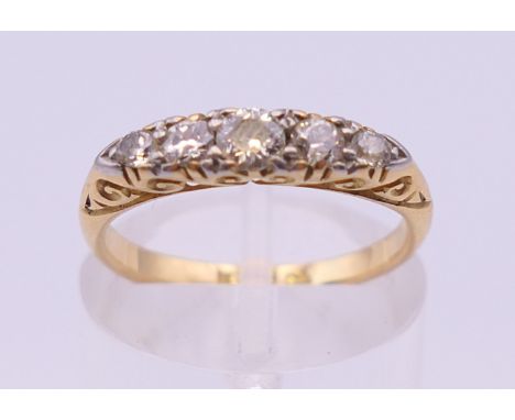 An 18 ct gold five stone diamond ring. Ring size K/L. 2.9 grammes total weight.