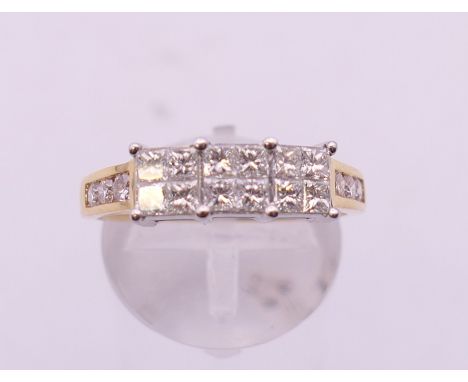 An 18 ct white and yellow gold 1 carat diamond cluster ring. Ring size Q/R. 4.2 grammes total weight.