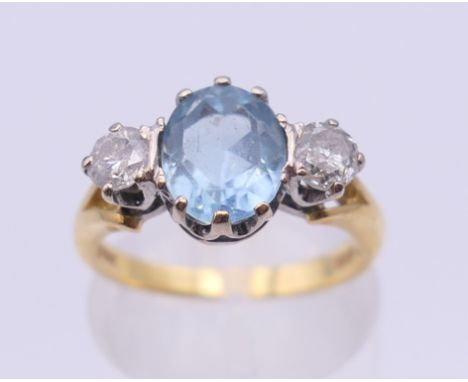 An 18 ct gold diamond and aquamarine ring.  Ring size L/M. 4.3 grammes total weight.