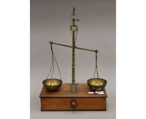 A set of brass and mahogany apothecary scales. 31.5 cm wide. 