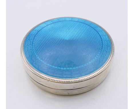 An American enamel decorated sterling silver box.  6.5 cm diameter. 