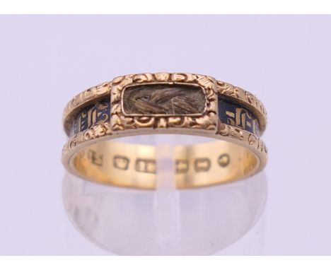 A Victorian 18 ct gold, enamel and hair plait set mourning ring. Ring size K/L. 3 grammes total weight. 