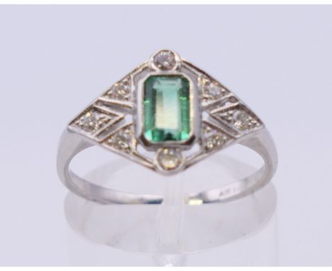 A platinum, diamond and emerald Art Deco style ring. Ring size N/O. 3.8 grammes total weight. 