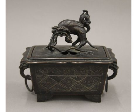 A 17th/18th century Chinese bronze censer and cover of rectangular form, decorated in the archaic style, ring handles and fo 