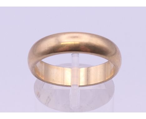 A 9 ct gold wedding band. Ring size Q/R. 5.1 grammes.
