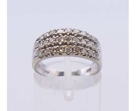A white gold three row diamond ring. Ring size N. 4 grammes total weight.