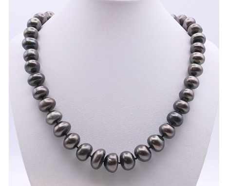 A black pearl bead necklace.  48 cm long. 